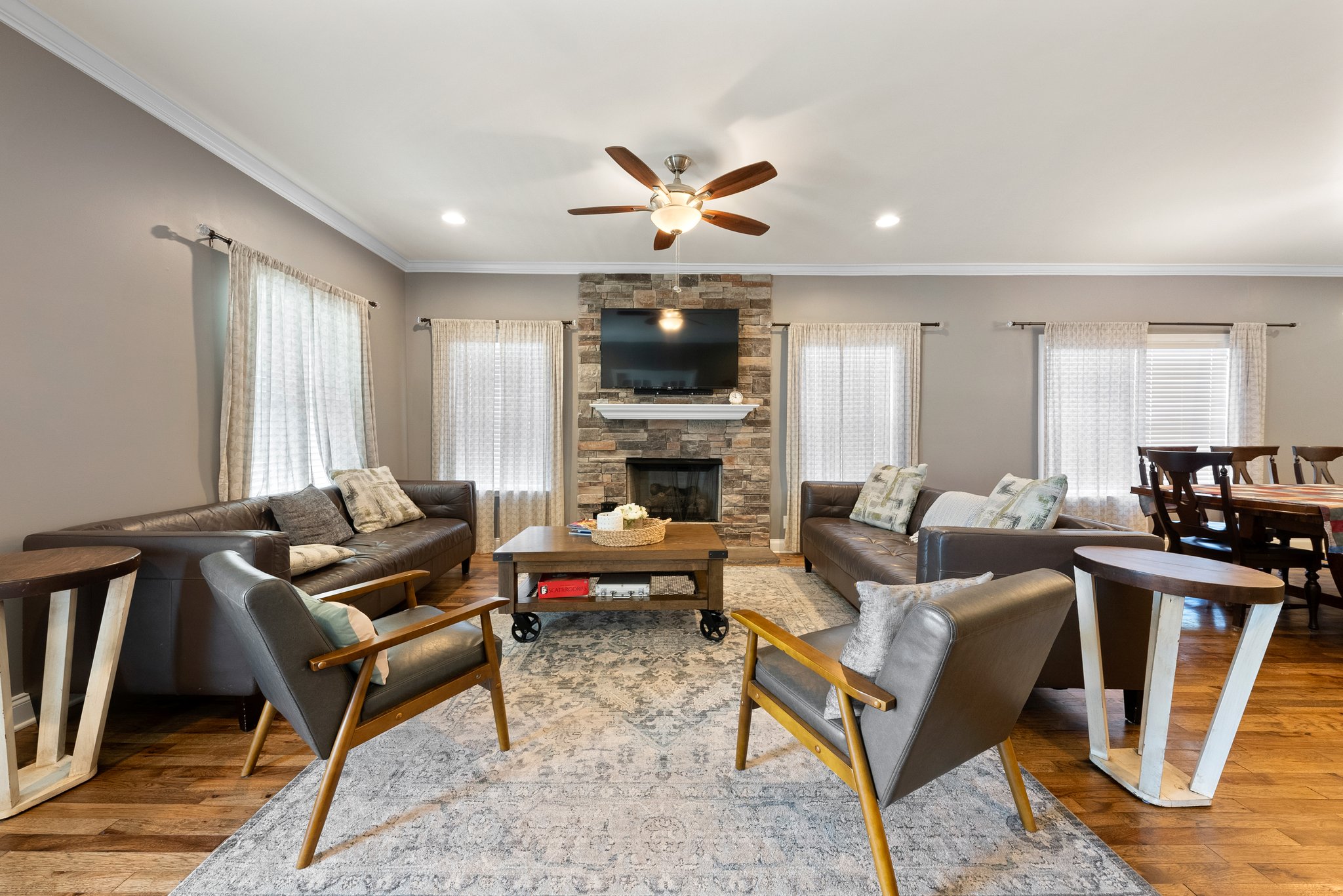 Cozy living room with fireplace, seating area, and large windows